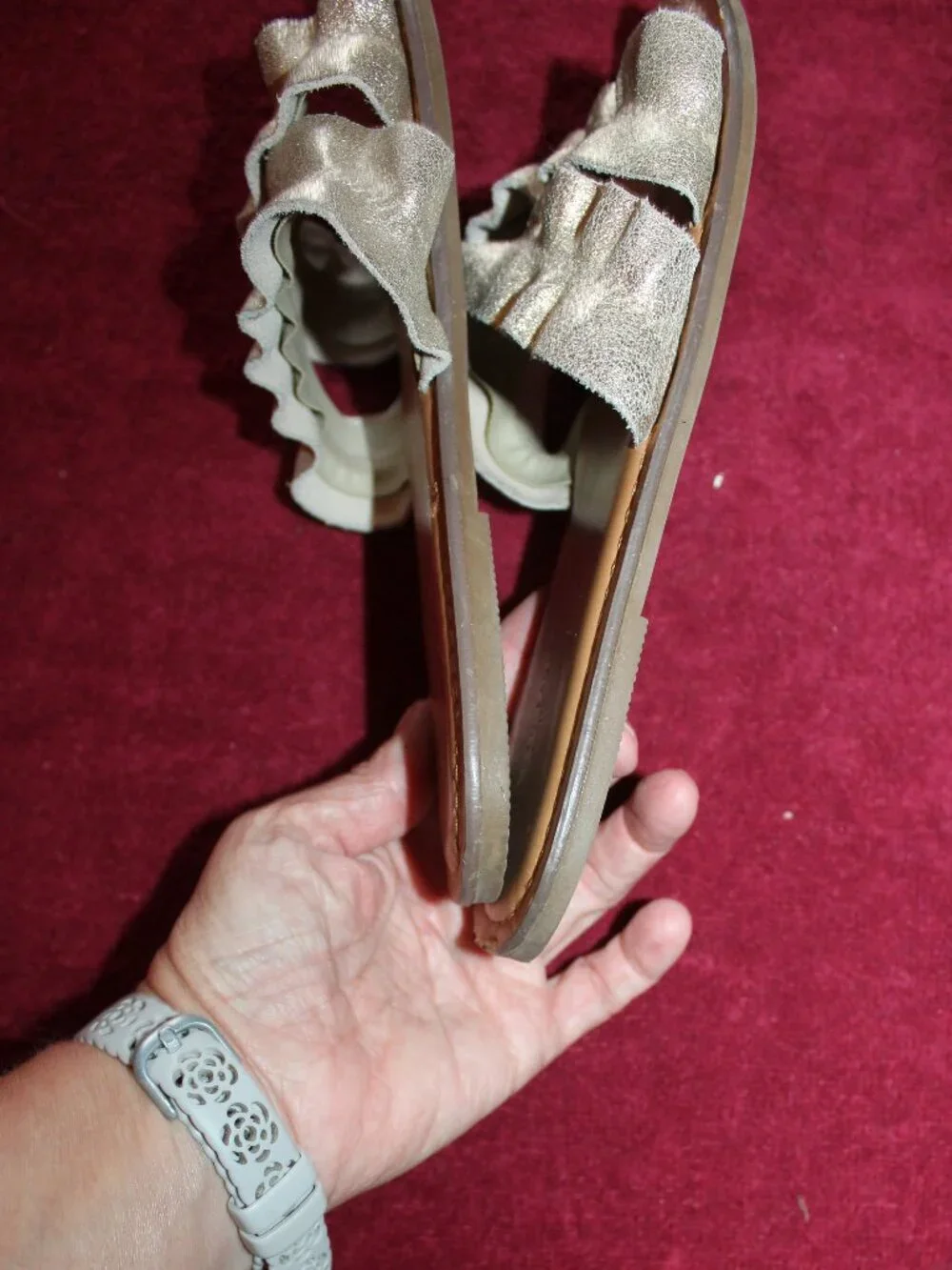 American Eagle Outfitters metallic gold double-strap ruffle slide sandals.